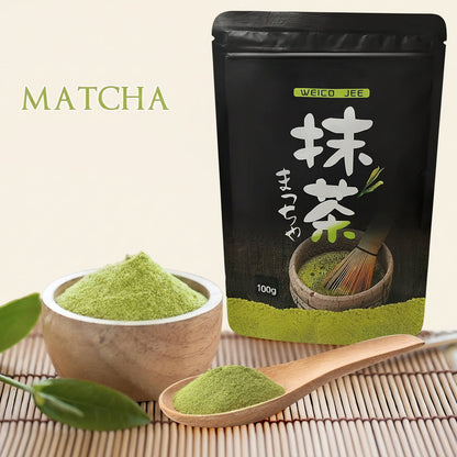 Matcha powder packaging with a scoop of matcha powder on a bamboo mat.