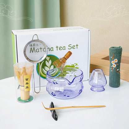 Purple Glass Matcha tea set with various tools and a box labeled 'Matcha tea set' on a white surface.