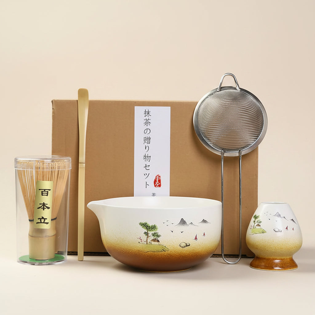 Tea-making set with bowl, whisk, and other tools on a gray surface.