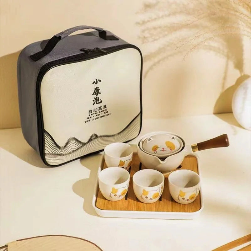 white cat Tea set with carrying case on a light surface
