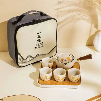 white cat Tea set with carrying case on a light surface