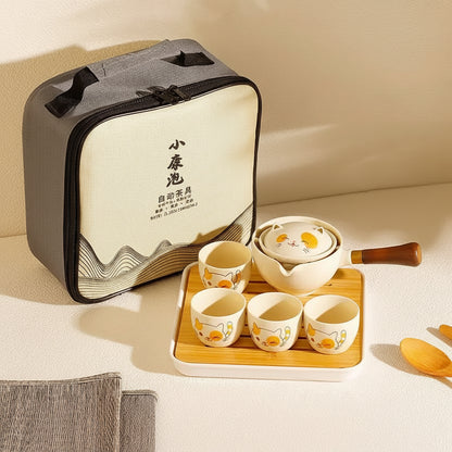 cat Tea set with four cups and a teapot on a wooden tray, accompanied by a carrying case.